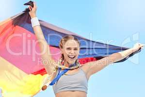 Portrait of winning athlete cheering, holding German flag after competing in sports. Smiling fit active sporty motivated woman. Celebrating achieving a gold medal in olympic sport with national pride