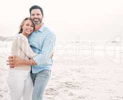 In each others arms is where we belong. Shot of a mature couple spending a day at the beach.