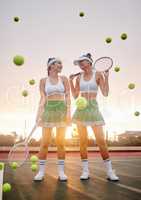 They come to see us win. two tennis players standing together on the court.