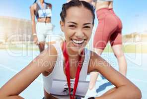 Closeup portrait of mixed race athletic woman with a medal from competing in sports event. Smiling fit active latino athlete feeling proud after winning running race. Track runner achieving goal