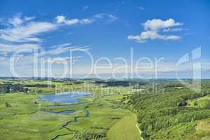 Countryside of Jutland, Denmark. Beautiful landscape showing the Danish wilderness. Pastures on a bright summer day with lush greenery flourishing and a blue sky filled with clouds.