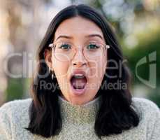 This cant be true. Closeup shot of woman looking surprised while standing outside.