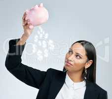 He who loses faith, loses all. a young female holding a piggy bank against a grey background.