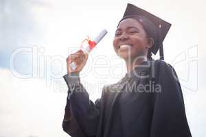 Be proud of what you can achieve. Portrait of a young woman cheering on graduation day.