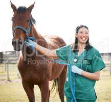 Hes as fit as a fiddle. Shot of an attractive young veterinarian standing alone and attending to a horse on a farm.