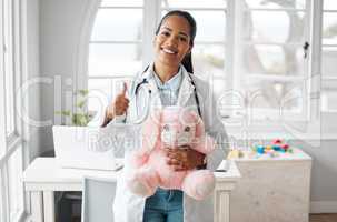 Being the best doctor I can be. Shot of a female pediatrician holding a teddy bear while giving the thumbs up.
