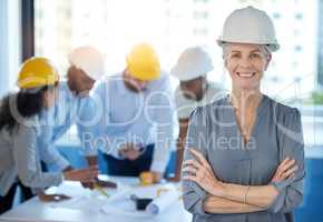 Running the construction industry. Shot of a mature businesswoman standing with her arms crossed in an office at work.