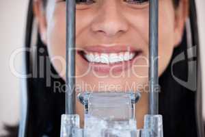 Closeup of a woman getting a digital x-ray scan of her mouth at the dentist. One female only smiling for a dental checkup. Patient taking care of her oral hygiene to maintain healthy teeth and gums