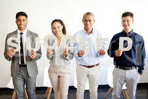 Your success is in your hands. a group of businesspeople holding letters that spell a word in an office at work.