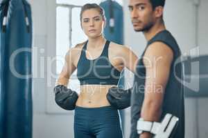 . Two people training together at the gym.