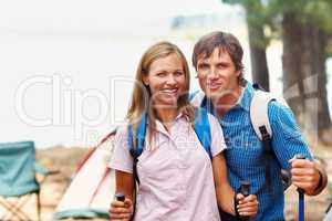 Ready for trekking. Portrait of smiling couple with backpack ready for trekking.