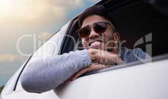 Nothing beats the open road. Shot of a handsome young man enjoying an adventurous ride in a car.