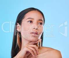 Skincare is very important to her. Studio shot of an attractive young woman posing against a blue background.