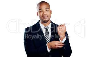 Dressed for business. Studio shot of a handsome young businessman fixing his sleeve against a white background.