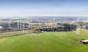Landscape aerial view of a farm in the countryside in summer. Agricultural field for farming, cultivation, and harvesting from above. An empty piece of land for vineyards, ranching, and growing crop