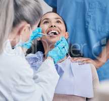 No skimping on the work. Shot of a young woman having a dental checkup.