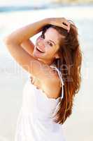 Pretty young female posing on beach. Portrait of a pretty young female posing on the sea shore.