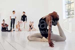 Dancing is very much a confession. a group of ballet dancers practicing a routine in a dance studio.