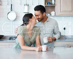 This is better than anything Ive ever experienced. Shot of a young couple having a cup of coffee together at home.
