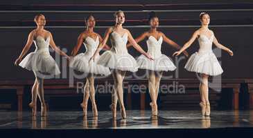 Dance every performance as if it were your last. a group of ballet dancers practicing a routine on a stage.