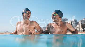 Dont count the laps, make the laps count. two young men going for a swim in an olympic pool.