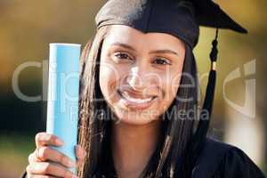 I studied. I cried. I conquered. Portrait of a young woman holding her diploma on graduation day.