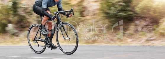 Young man showing his cycling skills while out cycling on a bicycle outside. Adrenaline junkie practicing a speed racing outdoors. Unrecognizable male training for a marathon on a bike