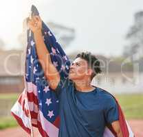 To the man upstairs. a handsome young male athlete pointing up at the sky while celebrating a victory for his country.