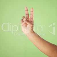 Im outta here. Cropped shot of a hand showing the peace sign against a green background.