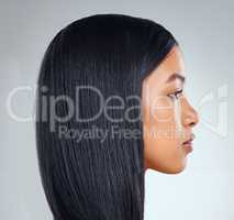 Sleek on fleek. Studio shot of an attractive young woman posing against a grey background.