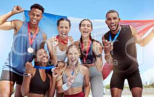 Happy and proud French olympic athletes celebrating winning medals for their country. Portrait of a diverse group of sports people with a French flag, cheering and proud of their success and victory