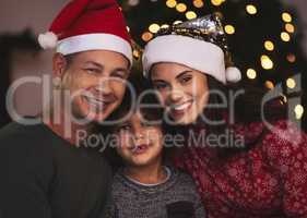 Were in the Christmas spirit. a young family celebrating Christmas at home.