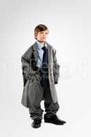 Todays students are tomorrows leaders. Studio shot of an adorable little boy dressing up as a businessman.