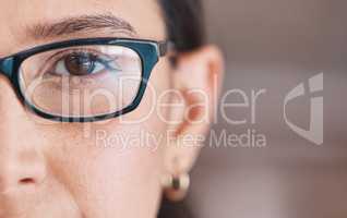 Closeup of the eye of a woman wearing glasses. The eye of a woman going for an optometry visit. Portrait of a woman testing her vision, eyesight. Young patient with brown eyes.