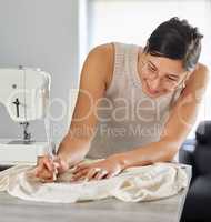 Crafting a unique creation. a young woman designing a garment in her workshop.