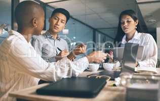 The best plans are made thoroughly. Shot of a group of businesspeople working late in a modern office.