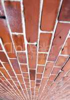 Perspective closeup of a red brick wall, copy space on home exterior, house or city building. Texture and detail background of strong, solid architecture construction design of facebrick on structure