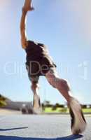 Athlete running on a sports track for fitness exercise in outdoor training practice. Below view of fit active man sprinting motion blur speed. Runner performing cardio workout for health and stamina