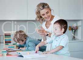 Single mother teaching little sons during homeschool class at home. Autistic cute little caucasian boys learning how to read and write while their single parent clap to motivate and support them