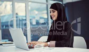 Shes here to make a name for herself. an attractive young arabic businesswoman working on her laptop in the office.