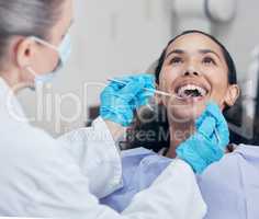 Giving her patients high end care. Shot of a young woman having a dental checkup.