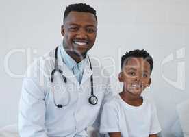 Hes all better. a young male doctor having a checkup with a little boy at a hospital.