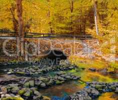 Landscape view of a fresh water river flowing under a cobblestone bridge in Norway. Scenery of transport infrastructure over a stream in a lush autumn forest while discovering a peaceful countryside