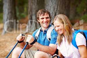 Happy couple taking a break from trekking. Happy couple taking a break from trekking and smiling.