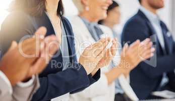 Happy businesswoman clapping hands for presentation during a meeting in an office boardroom with colleagues. Diverse group of businesspeople sitting in a row on a panel as audience and applauding after an inspiring and motivating talk