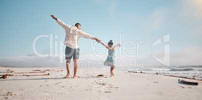 Full length rearview of unknown mixed race single father holding little daughters hand with copyspace. Adorable, hispanic girl walking and bonding with parent. Man and child enjoying beach free time