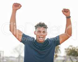 Im a champion. Cropped portrait of a handsome young male athlete standing outside with his hands in the air.