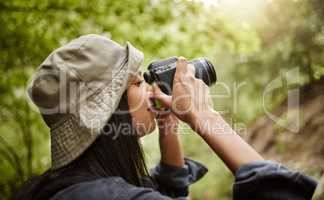Thats a great photo. Cropped shot of an attractive young woman taking photographs while hiking in the wilderness.