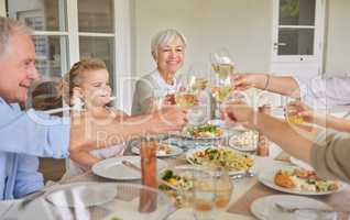 Family is all that we have. Shot of a family toasting during a sunday lunch.