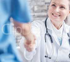 Thank you for assisting me in this medical procedure. Shot of a doctor shaking hands with a colleague in a medical office.